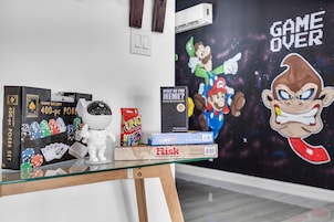 A glass display table with various board games and a wall art piece.