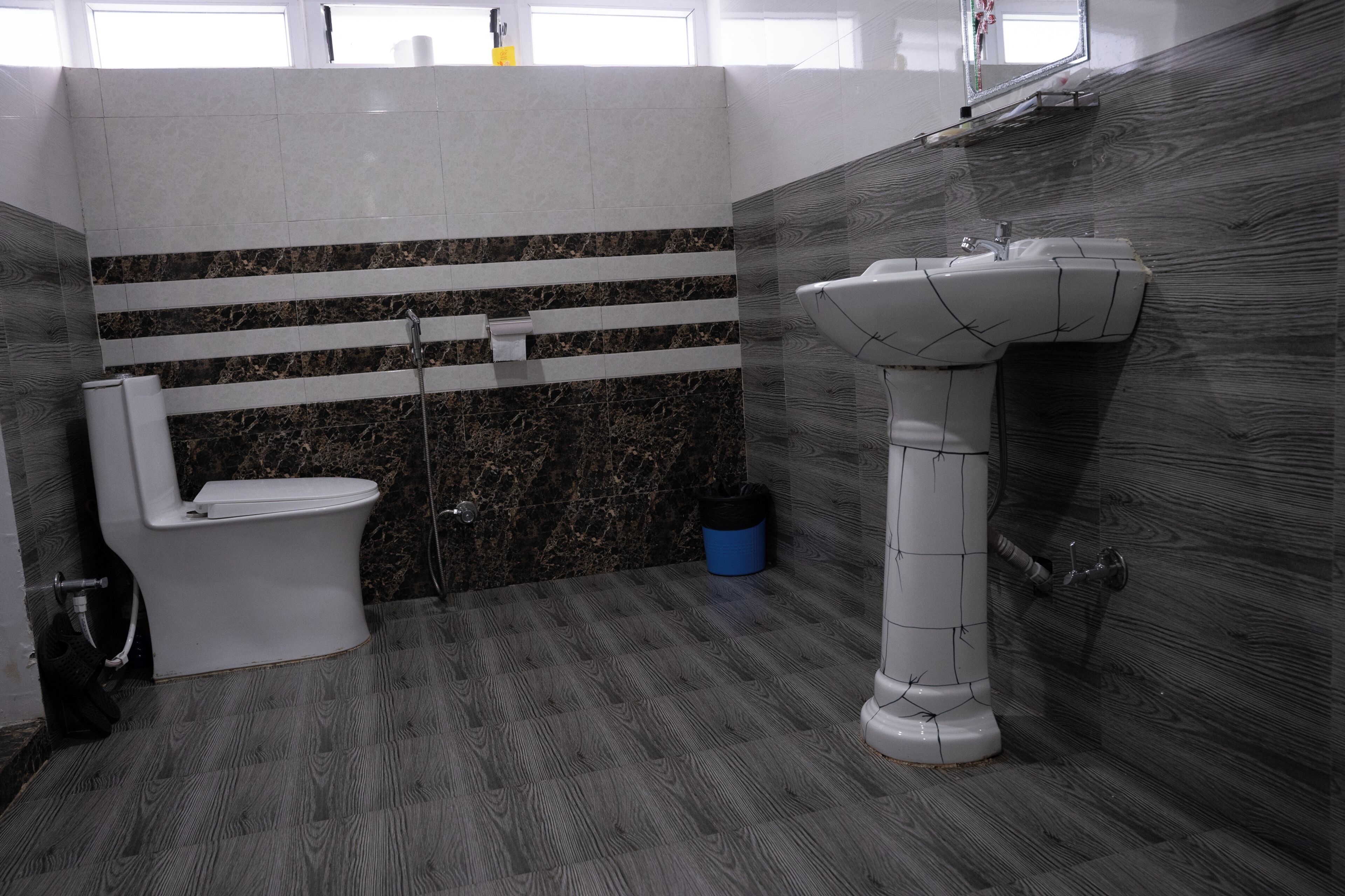 A bathroom with a toilet, a sink, and a shower.