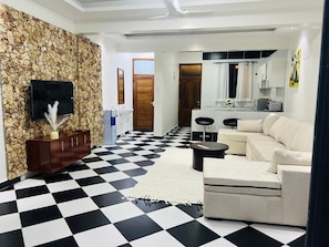 Deluxe Apartment, Balcony, Garden View | Living area | 32-inch Smart TV with digital channels - Baharini Cottages Diani (Diani Beach)