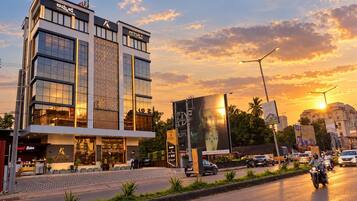 A hotel with a modern facade, a prominent entrance, and a large billboard.