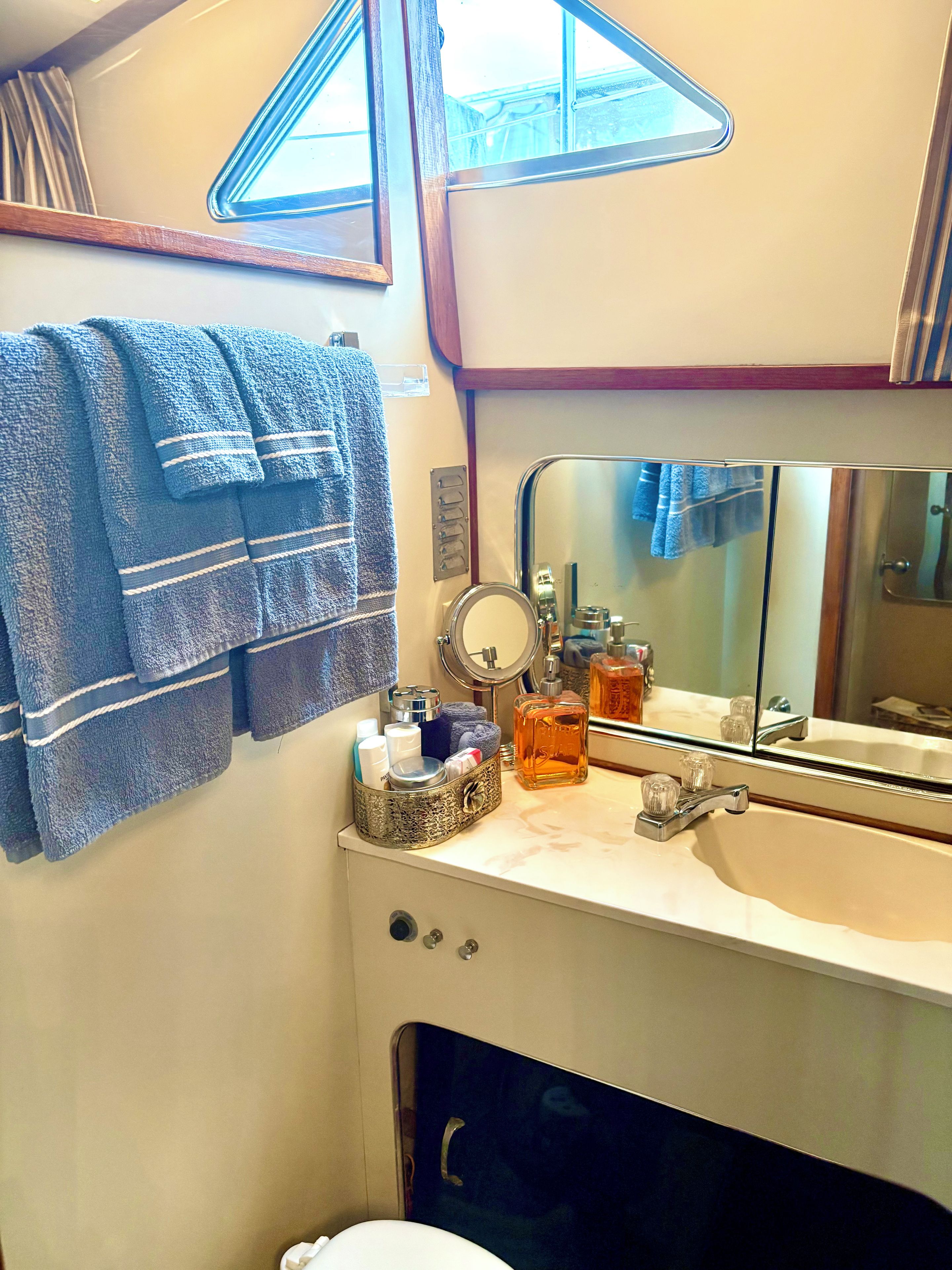 A bathroom with a sink, mirror, and towel rack.