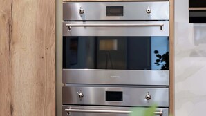 Una cucina con forno integrato e un pensile in legno.