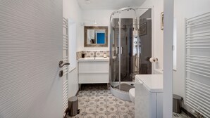 Un baño con ducha, inodoro y lavamanos.