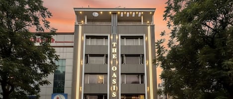 A multi-story hotel with a prominent sign reading "THE OASIS".