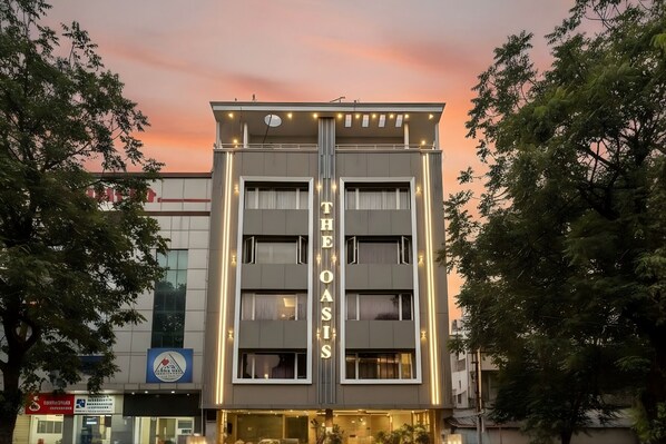 A multi-story hotel with a prominent sign reading "THE OASIS".