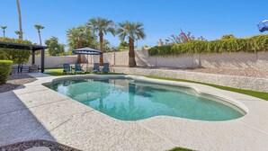 A swimming pool with a pergola and lounge chairs. - Elevated Desert Escape | Heated Pool • Putt Green (Scottsdale)