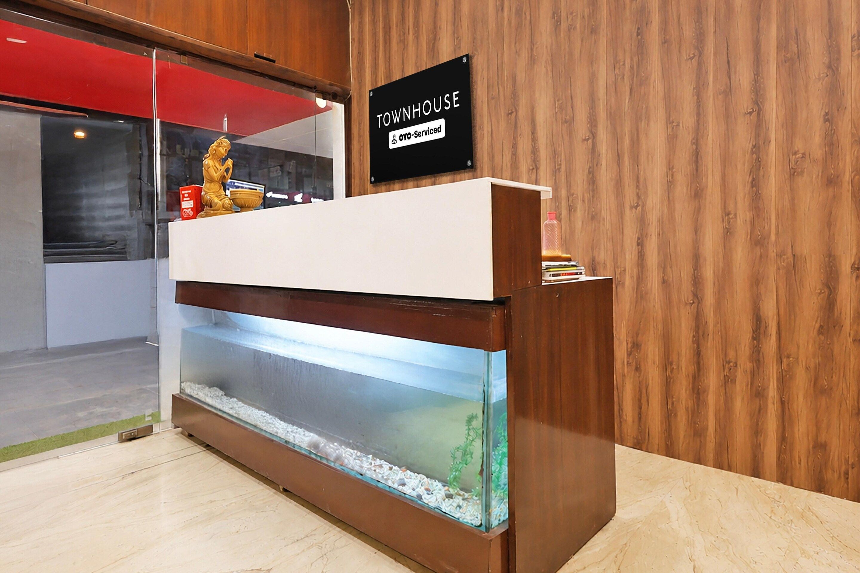 A reception desk with a sign indicating it is serviced by Oyo, a hotel.
