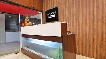A reception desk with a sign indicating it is serviced by Oyo, a hotel.