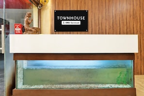 A reception desk with a sign indicating it is serviced by OYO. - Deluxe Hotel Sunbeam (Gwalior)