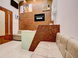 A reception area with a sign reading 'TOWNHOUSE' and a logo for 'YOYO-Serviced.' - Deluxe Room Parth Residency (Varanasi)