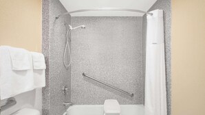 A bathroom with a shower, a bathtub, and a toilet.