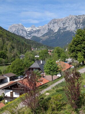 A mountainous landscape with residential buildings, including houses with red-tiled roofs and a church. - "In de Berg" Vacation Rental, 1–2 people, shower/toilet, Wi-Fi (Ramsau bei Berchtesgaden)