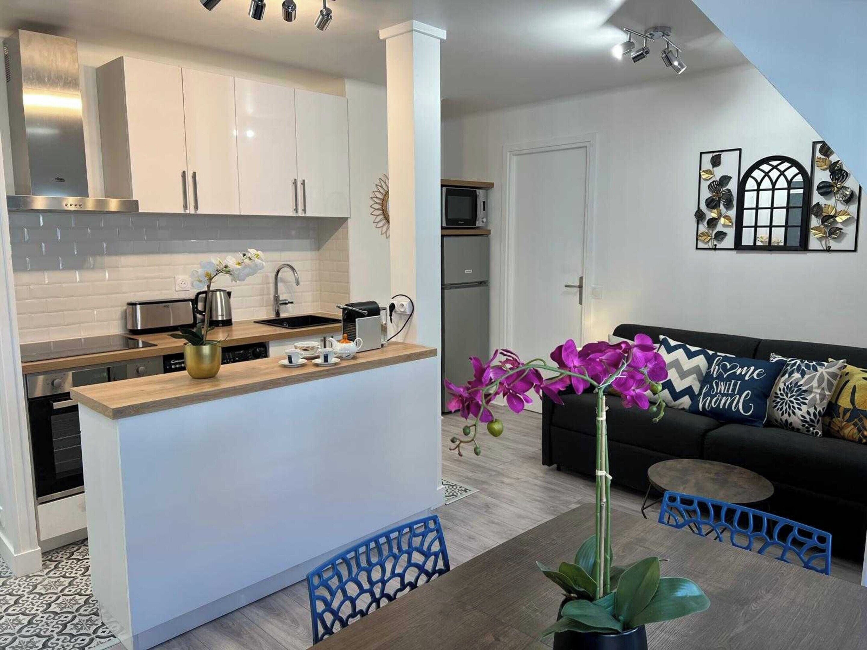 A modern kitchen with white cabinets, a wooden countertop, and a built-in oven.