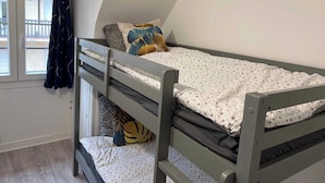 A bunk bed with a window and curtains, a small desk, and a view of the outside. - Charming Apartment 1br/6p - Deauville (Deauville)