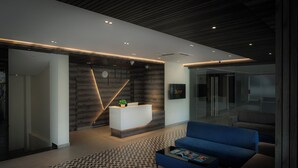 A modern reception area with a reception desk, seating area, and a clock on the wall. - Artis Connect Mysore  (Mysore)