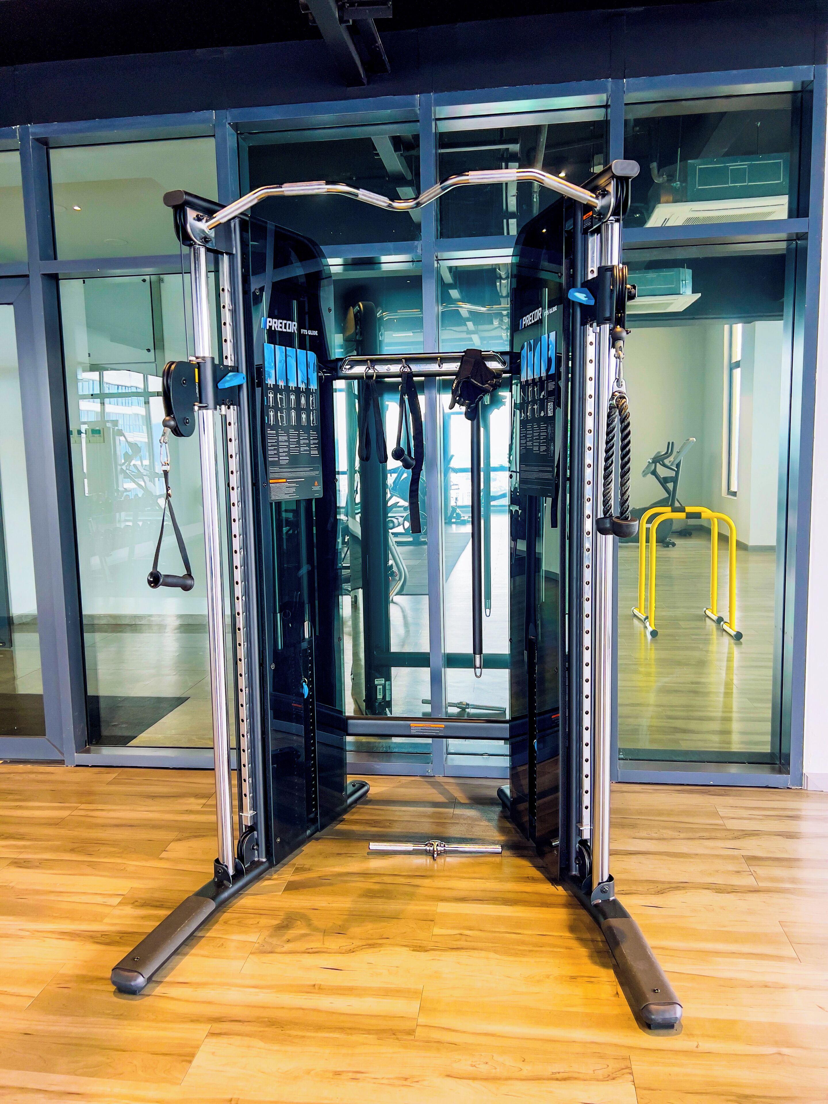 A gym with a pull-up bar, weight machines, and a yoga mat.