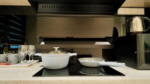 A modern kitchen with a built-in oven, a coffee maker, and a kettle on the countertop. - The Manor KLCC (Kuala Lumpur)