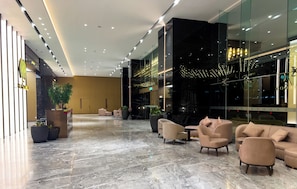 A modern lobby with marble flooring, seating areas, and a reception desk. - The Manor KLCC (Kuala Lumpur)