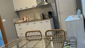 A modern kitchen with white cabinets, a stainless steel range hood, and a built-in oven. - Relax and be well in this fresh apartment for 4 + Parking on the island of Vir (Vir)
