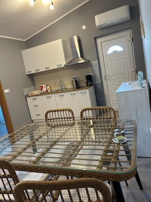 A modern kitchen with white cabinets, a stainless steel range hood, and a built-in oven. - Relax and be well in this fresh apartment for 4 + Parking on the island of Vir (Vir)