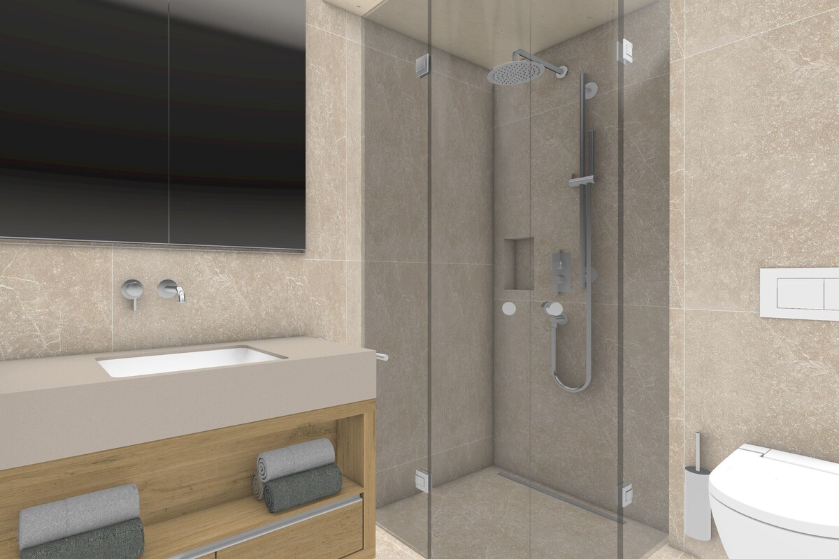 A modern bathroom with a glass-enclosed shower, a sink, and a toilet.