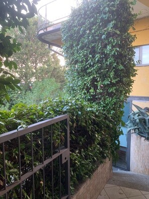 A staircase with a metal railing, surrounded by dense foliage. - Lake of Varese, "Residenza Mirabella" (Gavirate)