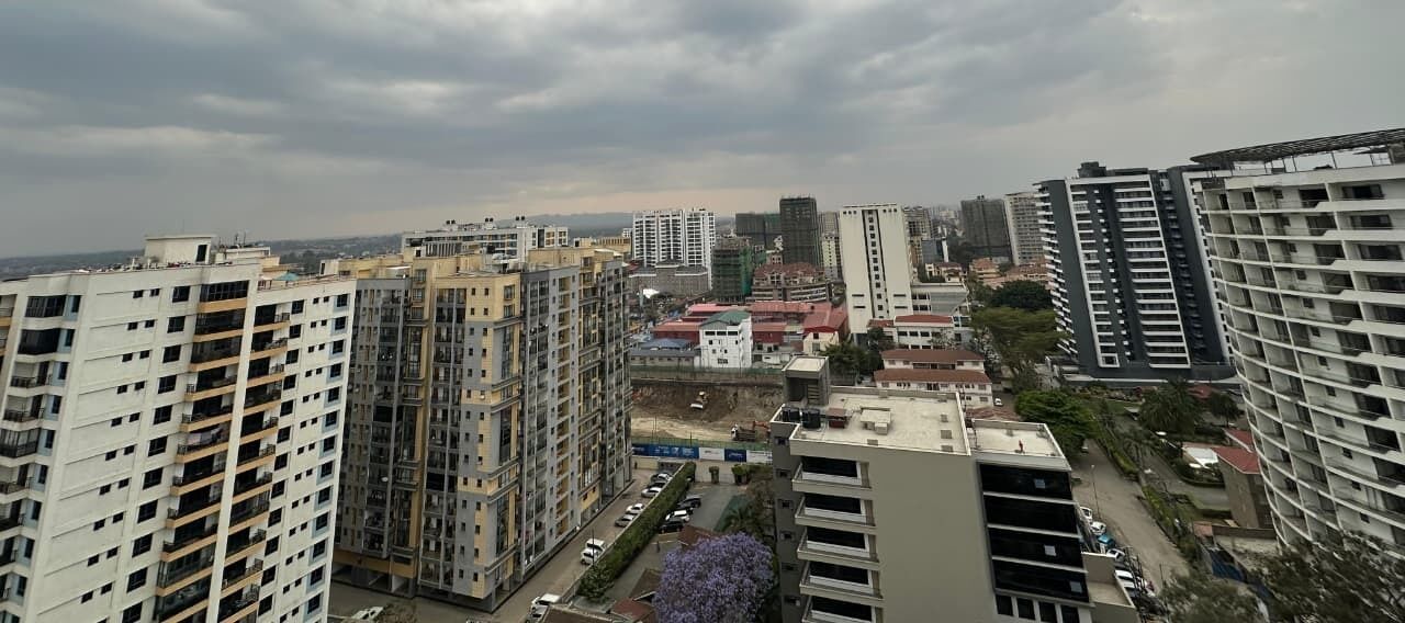 A high-rise urban area with multiple buildings, including residential and commercial structures.