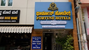 A hotel with a sign for 'Fortune Hotels' and 'Premium Executive Rooms'.