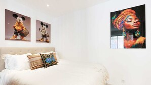 A bedroom with a bed, pillows, and two wall-mounted artworks. - 140m from the Palace of Festivals #Croisette #city center #air conditioning #Wi-Fi #elevator #terrace (Cannes)