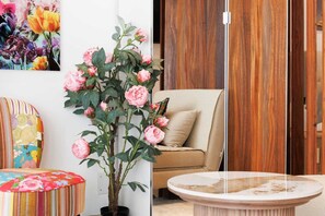 A room with a potted plant, a sofa, a chair, and a table. - 140m from the Palace of Festivals #Croisette #city center #air conditioning #Wi-Fi #elevator #terrace (Cannes)