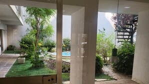 A view of a courtyard with a pool, potted plants, and a garden. - 140m from the Palace of Festivals #Croisette #city center #air conditioning #Wi-Fi #elevator #terrace (Cannes)