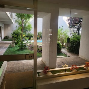 A view of a courtyard with a pool, potted plants, and a garden. - 140m from the Palace of Festivals #Croisette #city center #air conditioning #Wi-Fi #elevator #terrace (Cannes)
