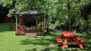 A gazebo with a roof and a picnic table in a grassy area. - Firepit, hot tub, sleeps 7, exclusive hiking for resort, volleyball, peaceful! (Sevierville)