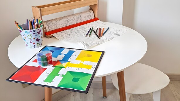 A round white table with a wooden chair, a colorful drawing board, and a cup of pencils. - Holiday Home 'El Niu Delta' with Wi-Fi and Air Conditioning (Deltebre)