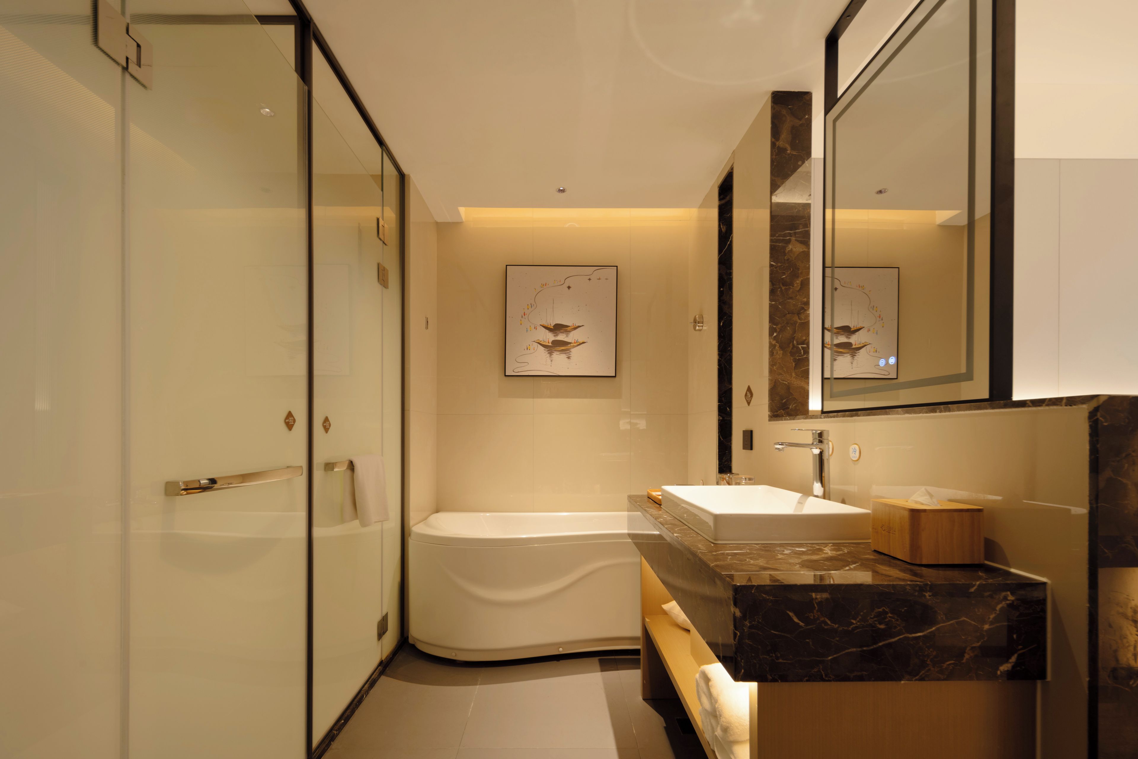 A modern bathroom with a glass shower enclosure, a freestanding bathtub, a marble vanity, and a large mirror.