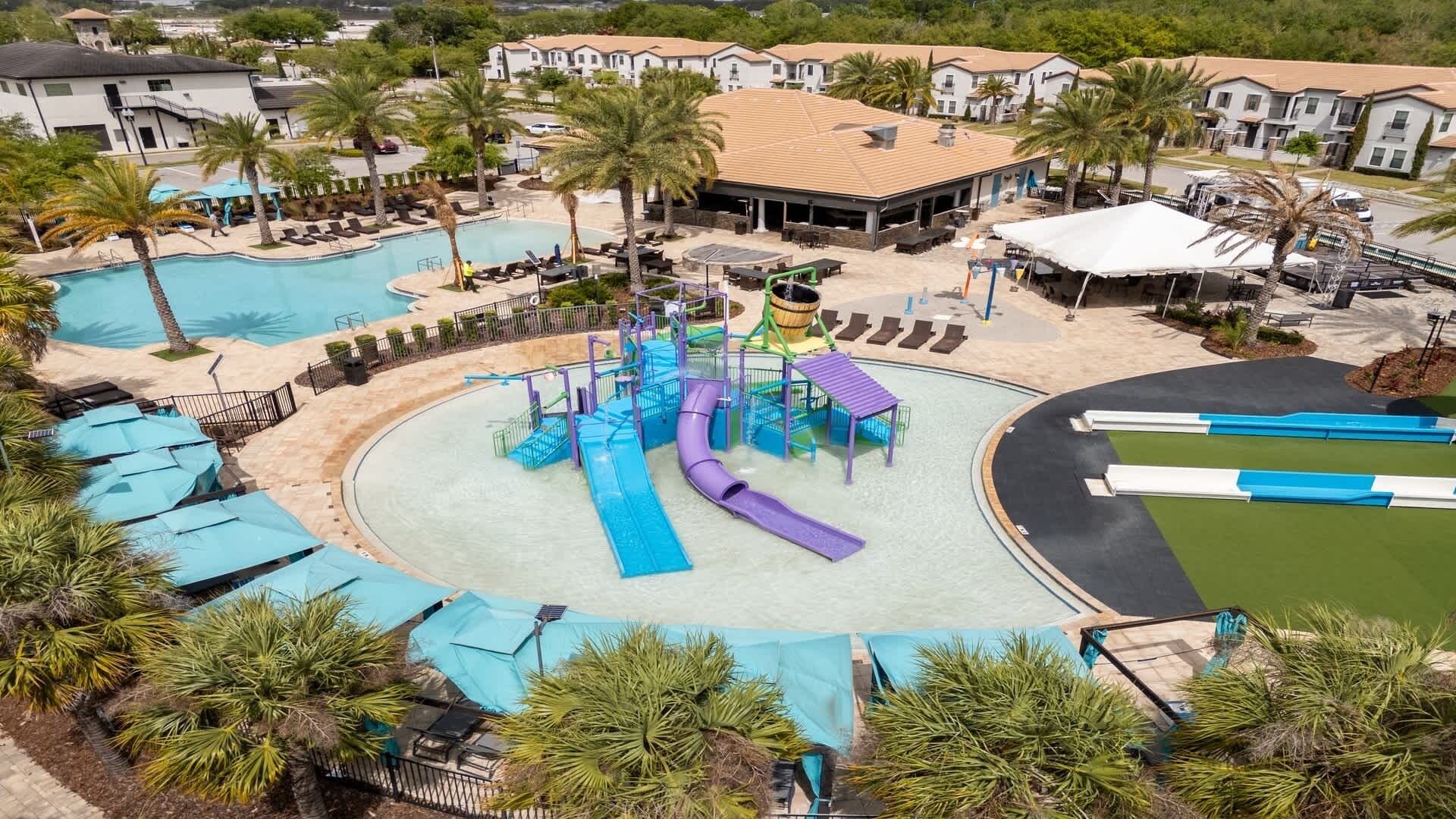 A resort with multiple swimming pools, a water park, and a variety of outdoor seating areas.