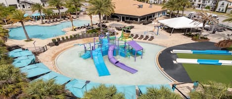 A resort with multiple swimming pools, a water park, and a variety of outdoor seating areas.
