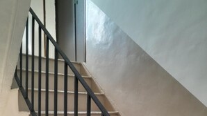 A staircase with black metal railings and beige steps. - Room 'Camera Tripla Comfort - 15' with Sea View, Wi-Fi and Air Conditioning (Cirella)
