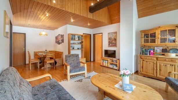 A spacious living area with a wooden ceiling, a sofa, a coffee table, and a television. - Haus Cervin - Inspiringplaces Zermatt (Zermatt)