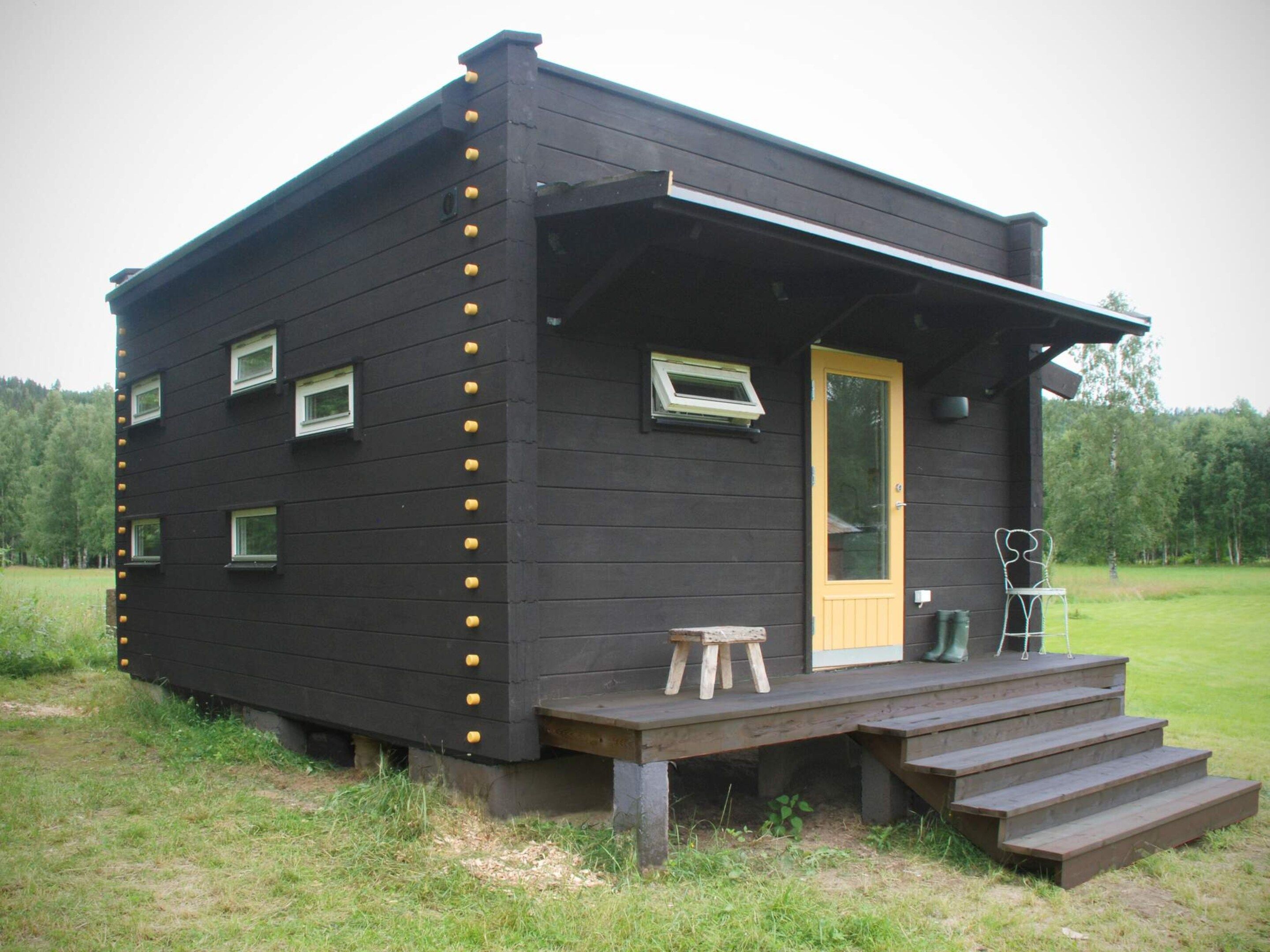 A small, single-story cabin with a front porch and a door.