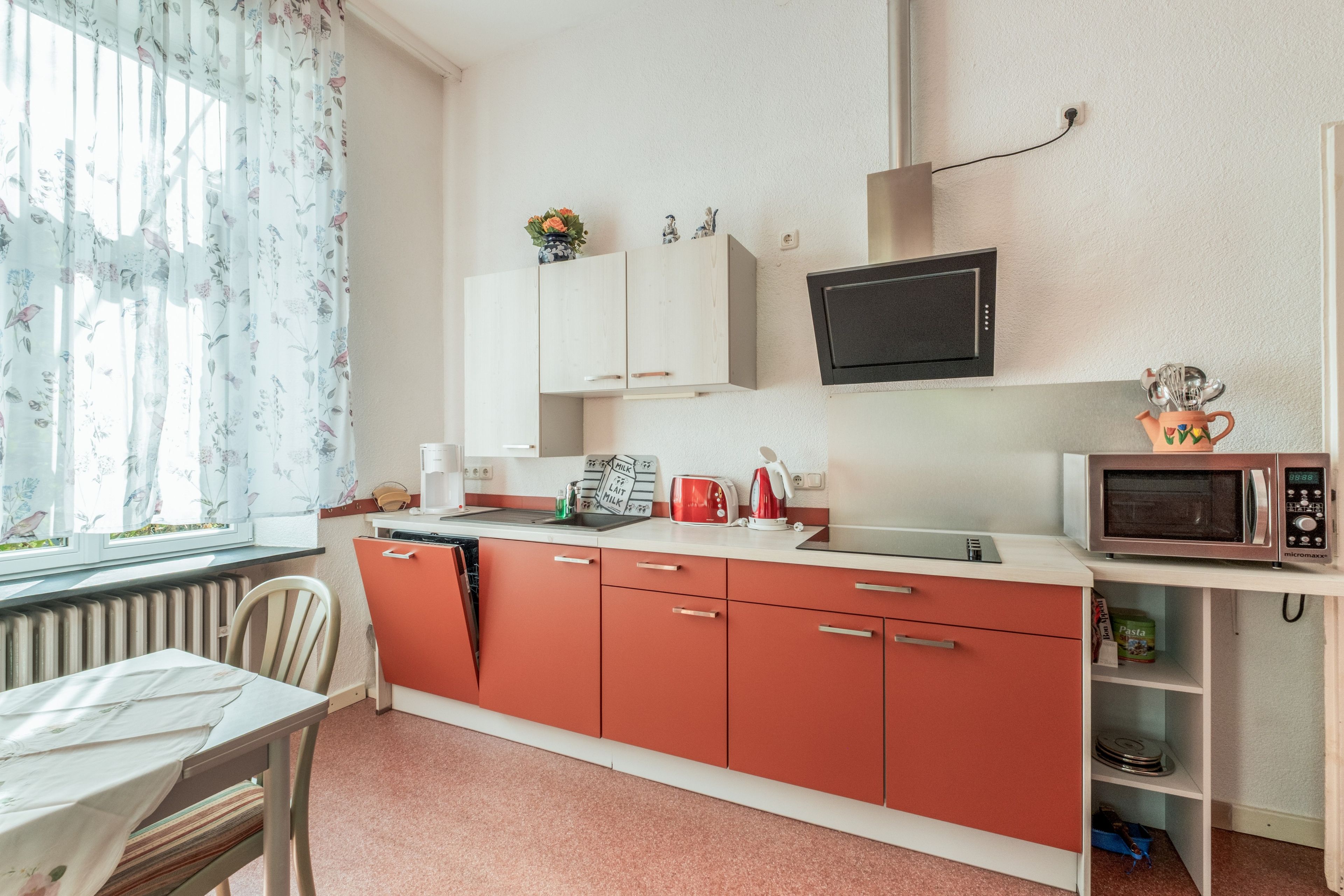 A compact kitchen with a sink, a microwave, and a toaster.