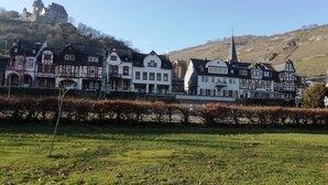 A row of traditional half-timbered houses with a castle in the background.