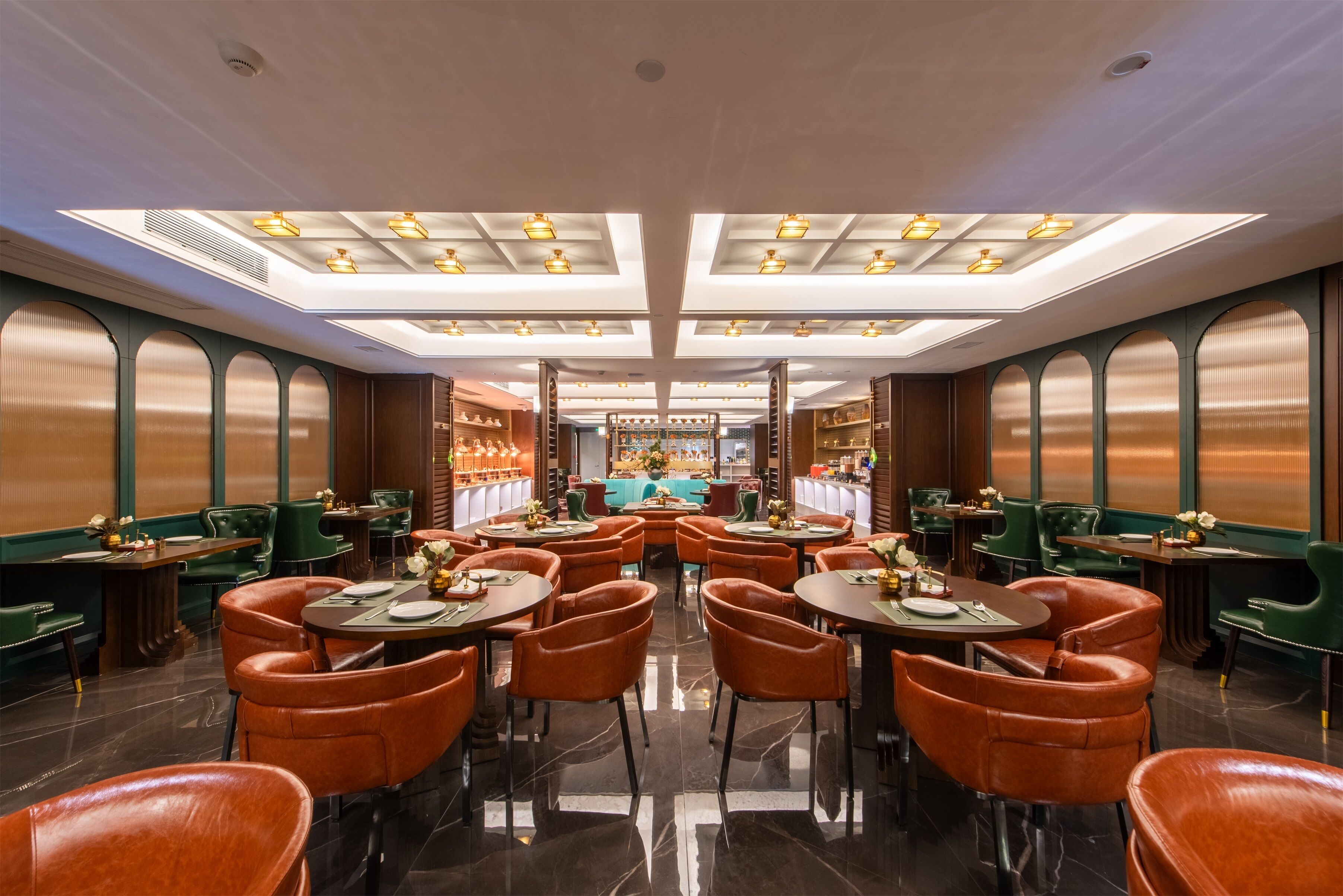 A restaurant with a central bar, multiple dining tables, and booths.