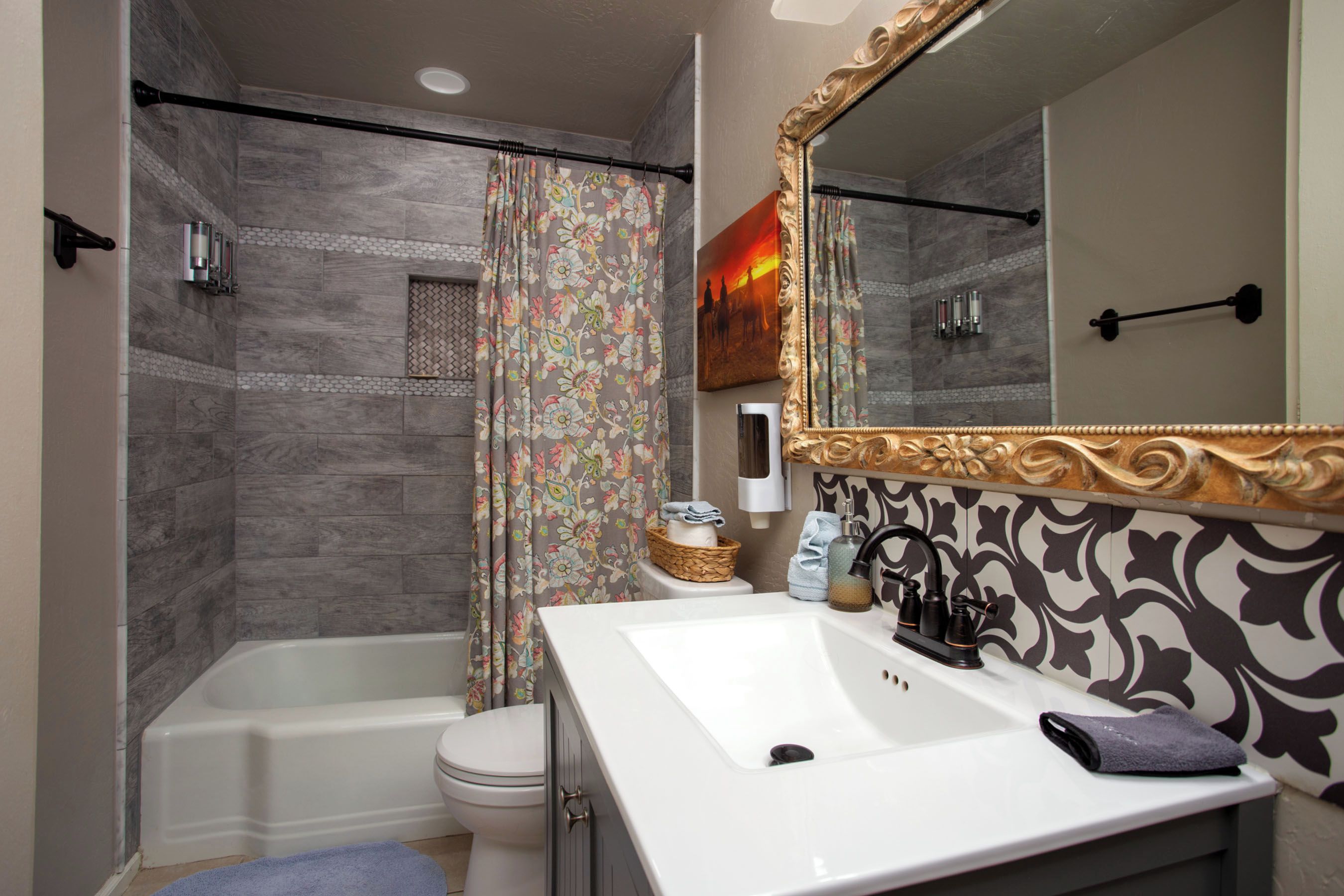 A bathroom with a bathtub, toilet, and sink.