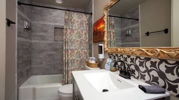 A bathroom with a bathtub, toilet, and sink.