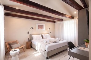 A bedroom with a bed, bedside table, lamp, chair, and a desk with a plant. - Villa Baracchi 4 BDR Pool Villa With Sauna in Krsan (Krsan)