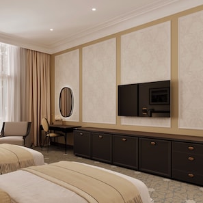 A hotel room with two beds, a desk with a chair, a television, and a large mirror.