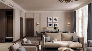 A spacious living room with a sofa set, armchairs, a coffee table, and a chandelier.