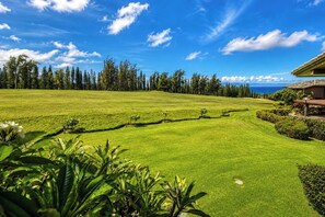 A golf course with a house in the background. - Kapalua Ridge | 2 Ocean View Villas, Sleeps 8 | Car Incl. w/ 6+ Nights | ML-4259 by KBM (Lahaina)