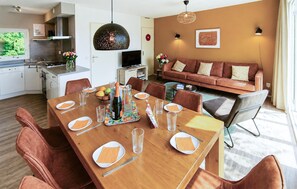 A modern living space with a dining area, kitchen, and a sofa set. - Stunning home in Vlagtwedde with sauna (Vlagtwedde)